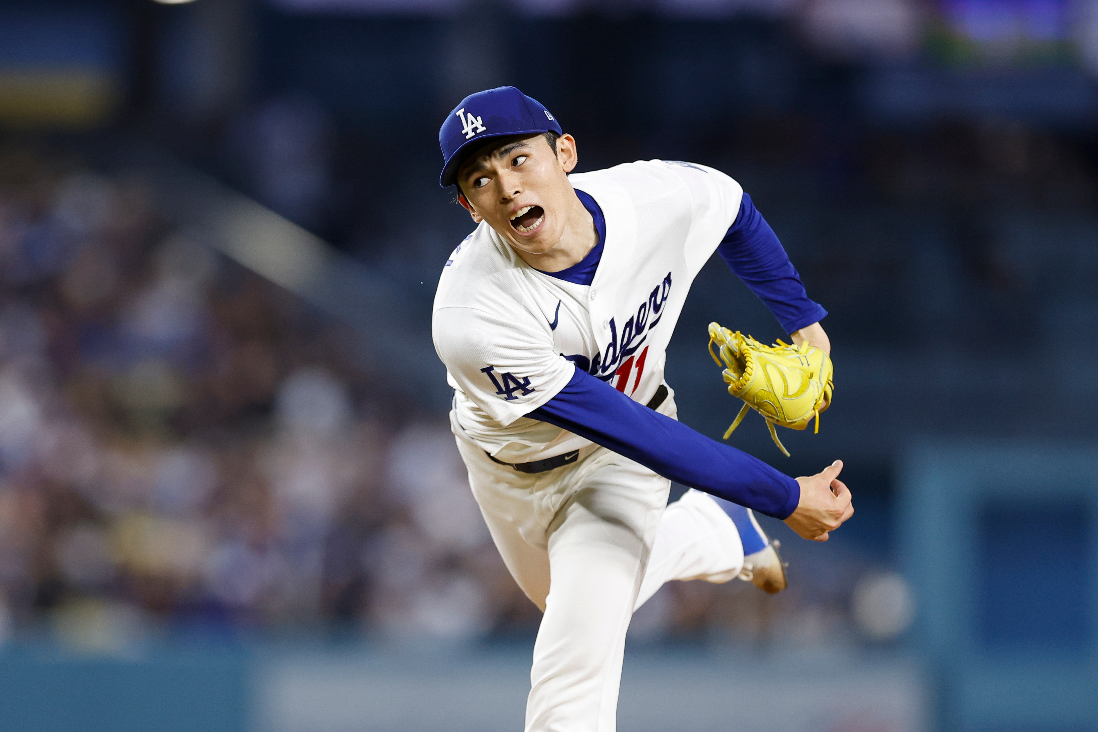 Dodgers starting pitcher Roki Sasaki throws to the plate during...