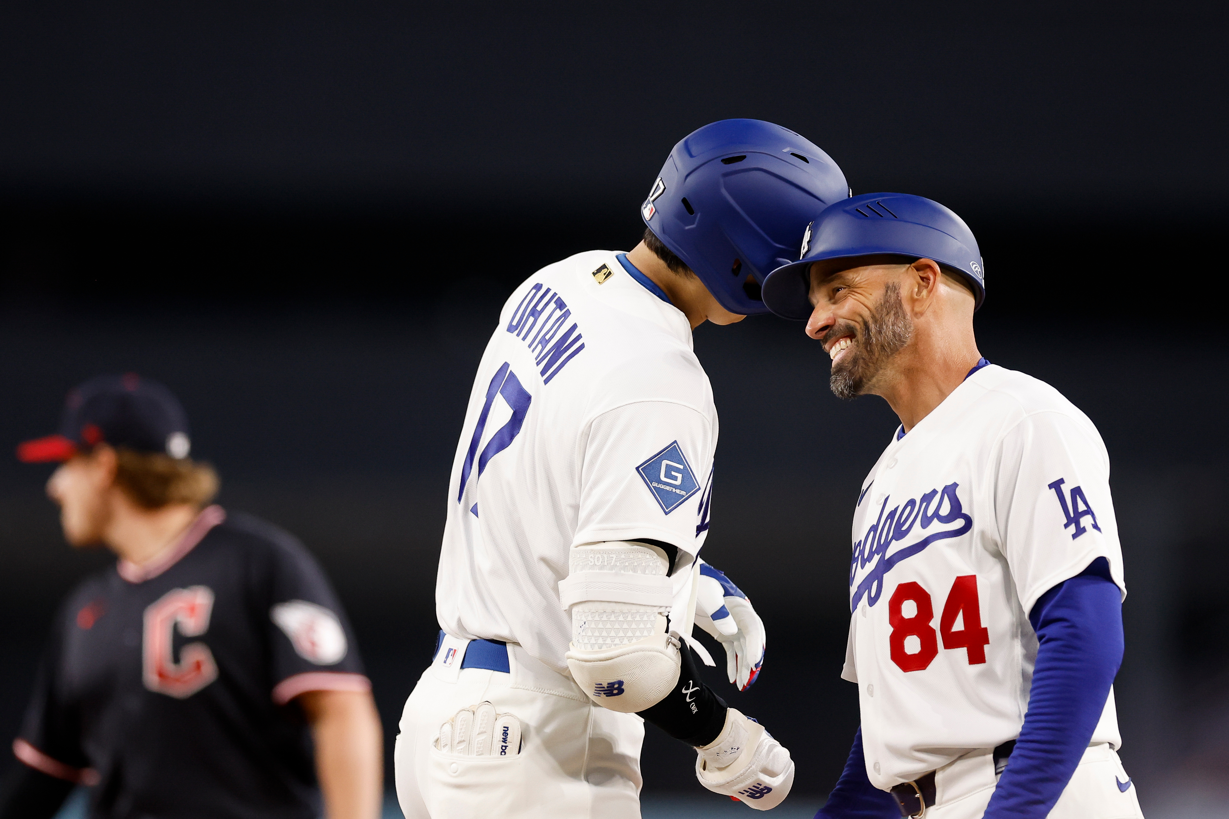 Dodgers star Shohei Ohtani, left, bumps helmets with Dodgers first...