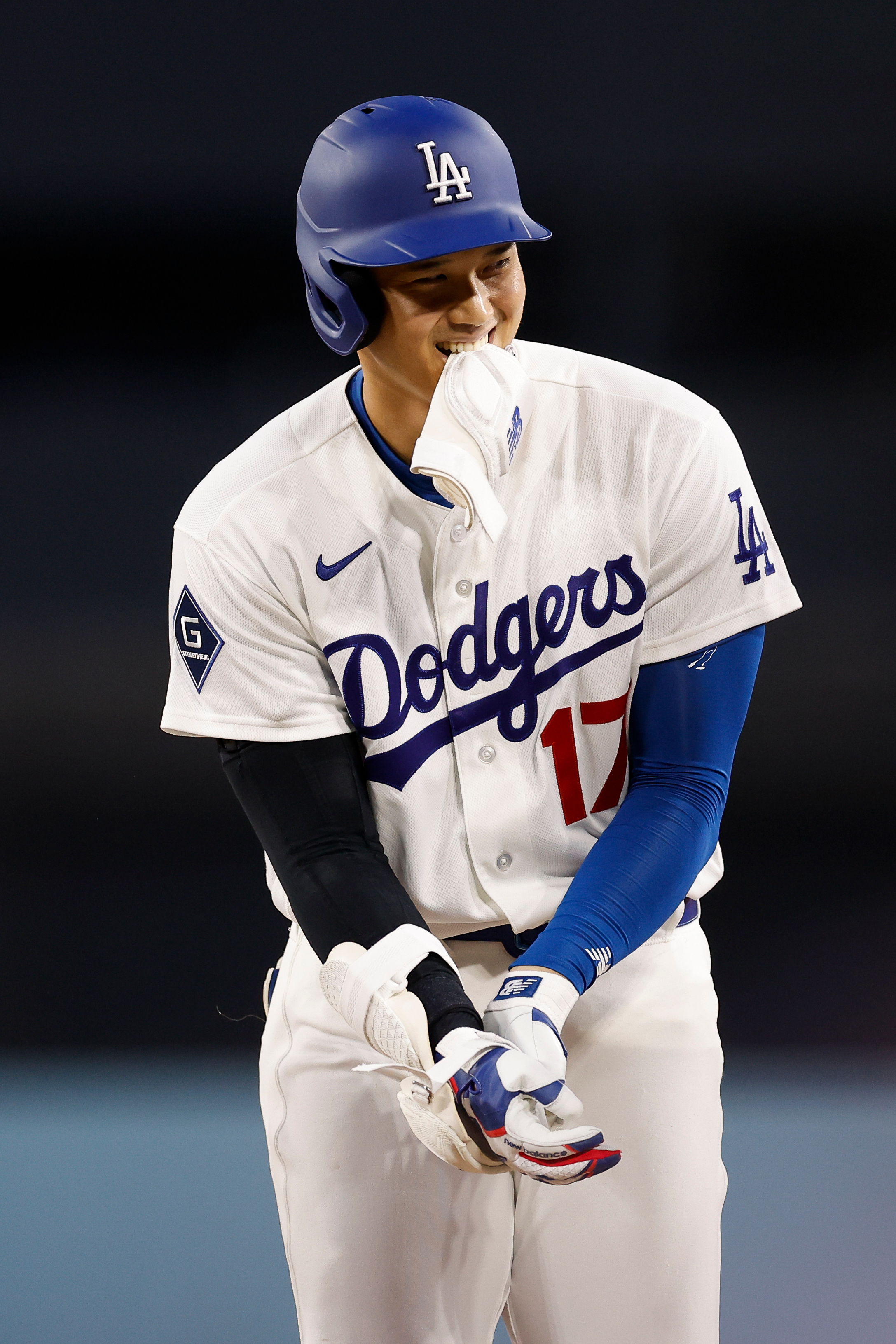 Dodgers star Shohei Ohtani takes some of his protective gear...