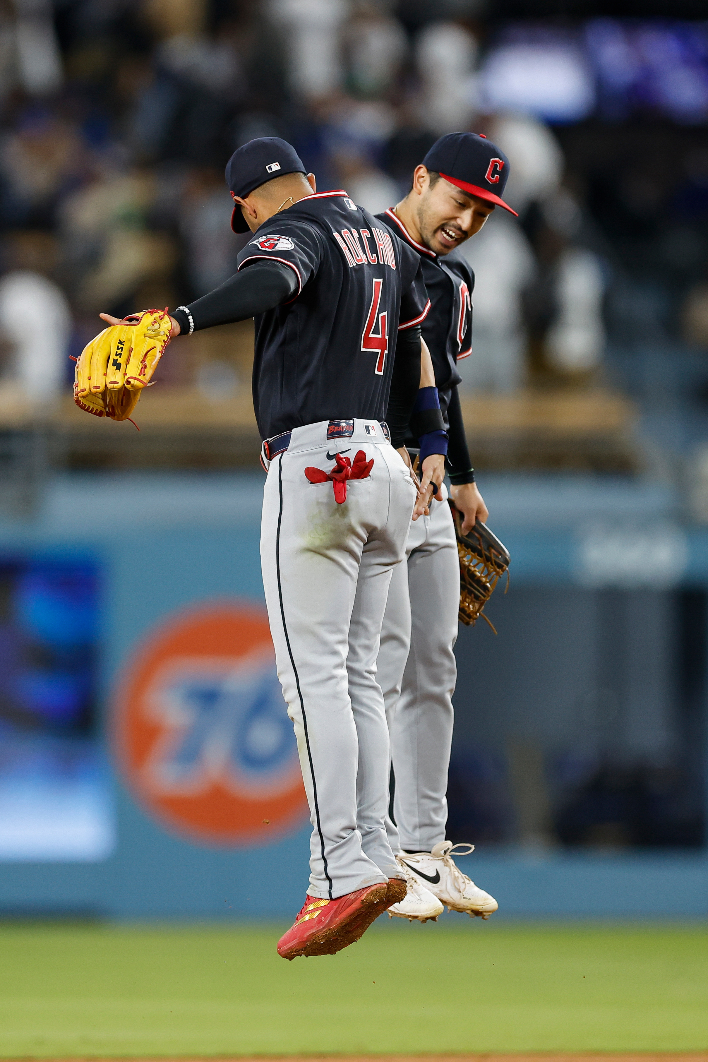Cleveland Guardians second baseman Brayan Rocchio, left, and left fielder...