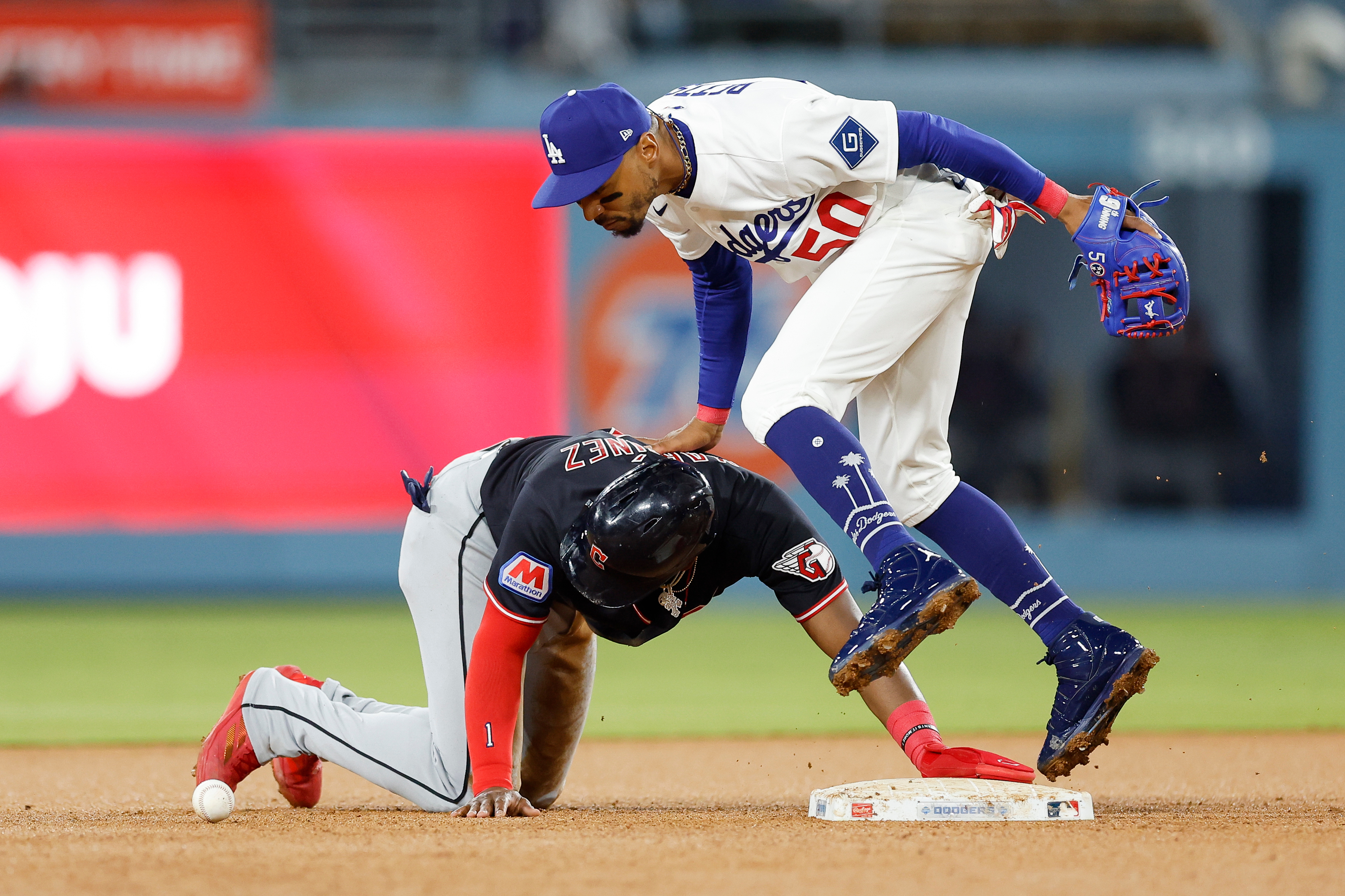 The Cleveland Guardians’ Angel Martinez, left, slides into second base...