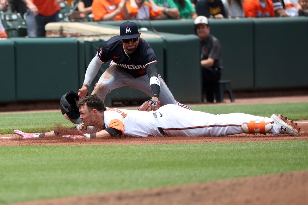 Minnesota Twins third baseman Royce Lewis tags put Baltimore Orioles' Ryan Mountcastle at third as Mountcastle tried to stretch a double into a triple during the fourth inning of a baseball game, Thursday, May 15, 2025, in Baltimore(AP Photo/Daniel Kucin Jr.)
