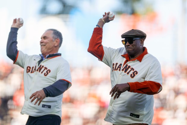 Former San Francisco Giants managers Bruce Bochy, left, and Dusty Baker throw the first pitch during Opening Night at Oracle Park in San Francisco, Calif., on Wednesday, March 25, 2026. (Shae Hammond/Bay Area News Group)