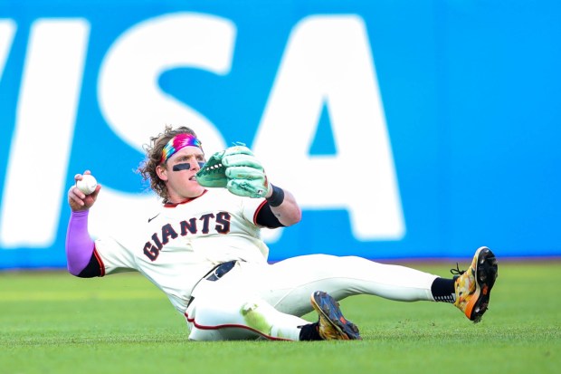 San Francisco Giants' Harrison Bader (9) throws the ball to second after making a sliding catch for an out on a ball hit by New York Yankees' Trent Grisham (12) in the fourth inning of their opening night MLB game at Oracle Park in San Francisco, Calif., on Wednesday, March 25, 2026. (Ray Chavez/Bay Area News Group)