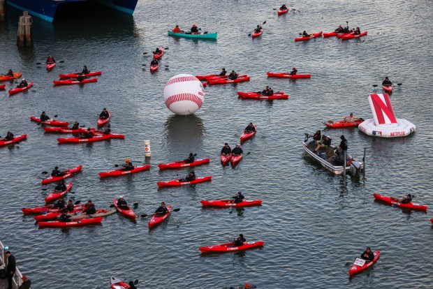 Fans in red canoes sponsored by Netflix navigate at the McCovey Cove during the opening night MLB game between the San Francisco Giants and the New York Yankees at Oracle Park in San Francisco, Calif., on Wednesday, March 25, 2026. (Ray Chavez/Bay Area News Group)