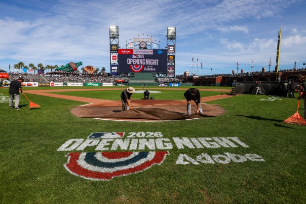 Field crew works on the final touches for the opening night MLB game between the San Francisco Giants and the New York Yankees at Oracle Park in San Francisco, Calif., on Wednesday, March 25, 2026. (Ray Chavez/Bay Area News Group)