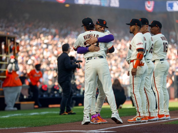 San Francisco Giants Tony Vitello and San Francisco Giants' Willy Adams (2) hug during Opening Night against the New York Yankees at Oracle Park in San Francisco, Calif., on Wednesday, March 25, 2026.  (Shae Hammond/Bay Area News Group)
