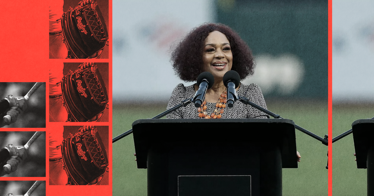 A woman with curly hair stands at a podium labeled "Oracle Park," speaking into two microphones, with red and black baseball-themed images on the left.