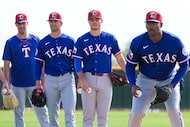 Texas Rangers pitcher Kumar Rocker (right) participates in a fielding drill with (from left)...