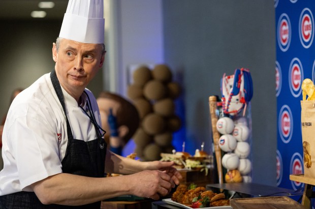 David Burns, senior executive chef for Levy Restaurants at Wrigley Field, walks with a Chicken & Churros dish during the Taste of Wrigley Field event on March 20, 2026. (Josh Boland/Chicago Tribune)