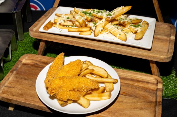 Garlic Parmesan Fries and Chicken Tenders on display during the Taste of Wrigley Field event in the Home Plate Room on March 20, 2026. (Josh Boland/Chicago Tribune)