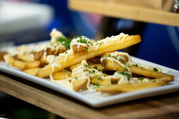 Garlic Parmesan Fries on display during the Taste of Wrigley Field event in the Home Plate Room on March 20, 2026. The dish includes fries covered with garlic aioli, parmesan and parsley. (Josh Boland/Chicago Tribune)