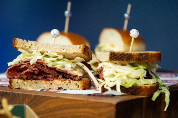 The Rami sandwich on display during the Taste of Wrigley Field event on March 20, 2026. The dish includes pastrami, swiss cheese, coleslaw, Russian dressing and a pickle spear. (Josh Boland/Chicago Tribune)