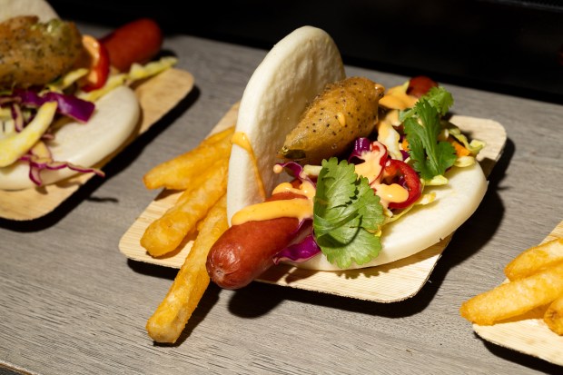 The Bao Wow Dog on display during the Taste of Wrigley Field event on March 20, 2026. The dish includes a beef hot dog on a bao bun with mustard, tempura short peppers, Fresno peppers and sriracha aioli. (Josh Boland/Chicago Tribune)