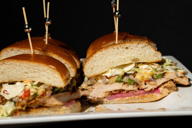The Kingston sandwich on display during the Taste of Wrigley Field event on March 20, 2026. The dish includes grilled chicken, pineapple salsa, spicy slaw, pickled red onion and garlic aioli. (Josh Boland/Chicago Tribune)