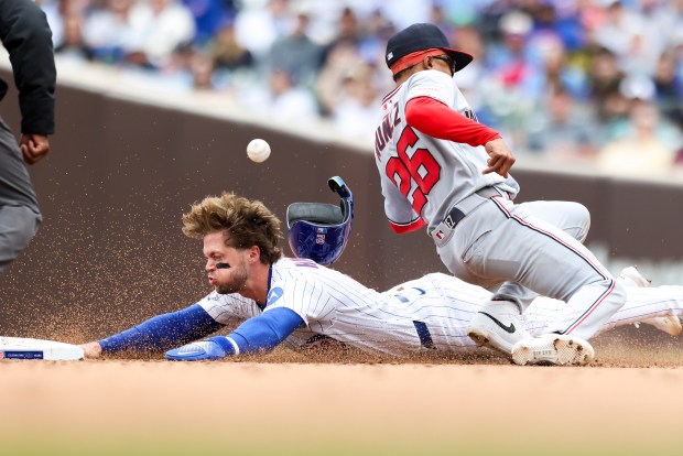 Chicago Cubs second baseman Nico Hoerner (2) steals second base as Washington Nationals shortstop Nasim Nuñez (26) misses the throw during the fourth inning at Wrigley Field on Sunday, March 29, 2026. (Eileen T. Meslar/Chicago Tribune)
