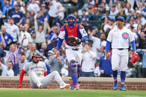 Chicago Cubs pitcher Daniel Palencia, right, celebrates with catcher Carson Kelly after he tagged Washington Nationals second baseman Luis García Jr. out at home plate to get out of the top of the ninth inning at Wrigley Field on Sunday, March 29, 2026. (Eileen T. Meslar/Chicago Tribune)