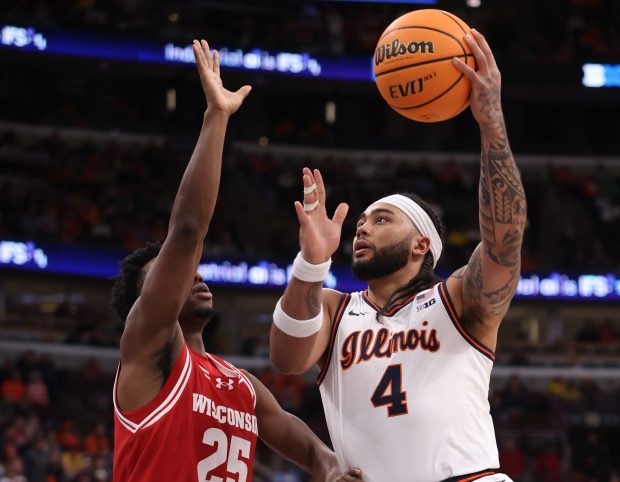 Illinois guard Kylan Boswell aims for the basket as Wisconsin guard John Blackwell defends during the Big Ten Tournament at the United Center on March 13, 2026. (John J. Kim/Chicago Tribune)