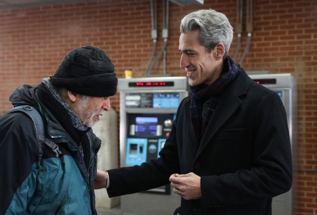 Evanston Mayor Daniel Biss greets a passenger at the CTA Davis station in Evanston on March 18, 2026, following his primary election night win for the Democratic nomination in the 9th Congressional District of Illinois. (John J. Kim/Chicago Tribune)