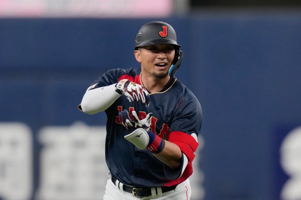 Seiya Suzuki of Japan reacts after hitting a home run in an exhibition game against the Hanshin Tigers on Tuesday, March 3, 2026 in Osaka. (AP Photo/Eugene Hoshiko)