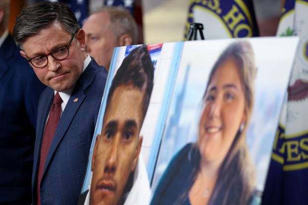 Speaker of the House Mike Johnson, R-Louisiana, looks at photos of Jose Medina and Sheridan Gorman during a press conference on March 25, 2026, on Capitol Hill in Washington, D.C. (Tasos Katopodis/Getty)