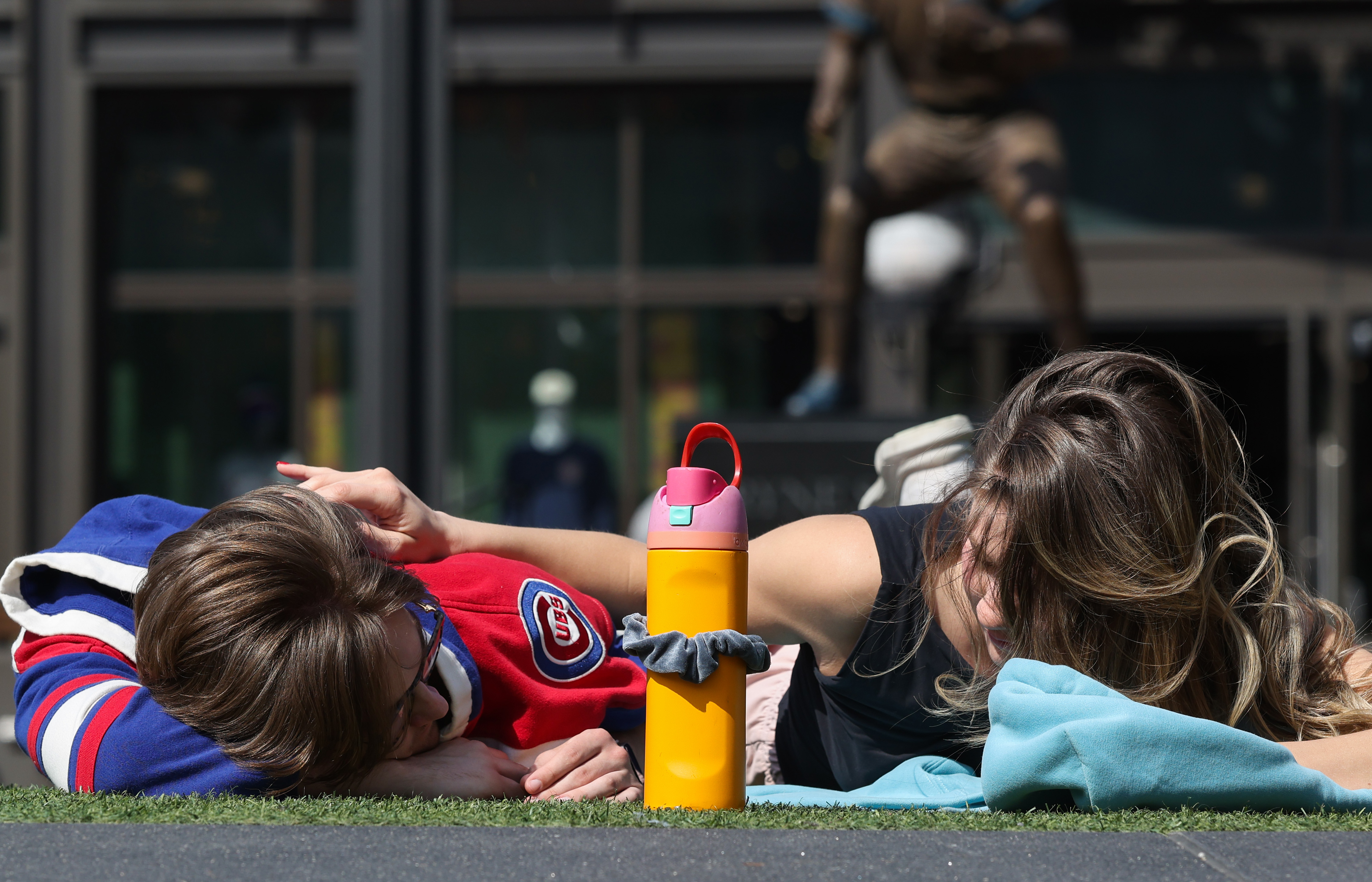 Eric Amundson and Jenny Couch lie in the sun at...
