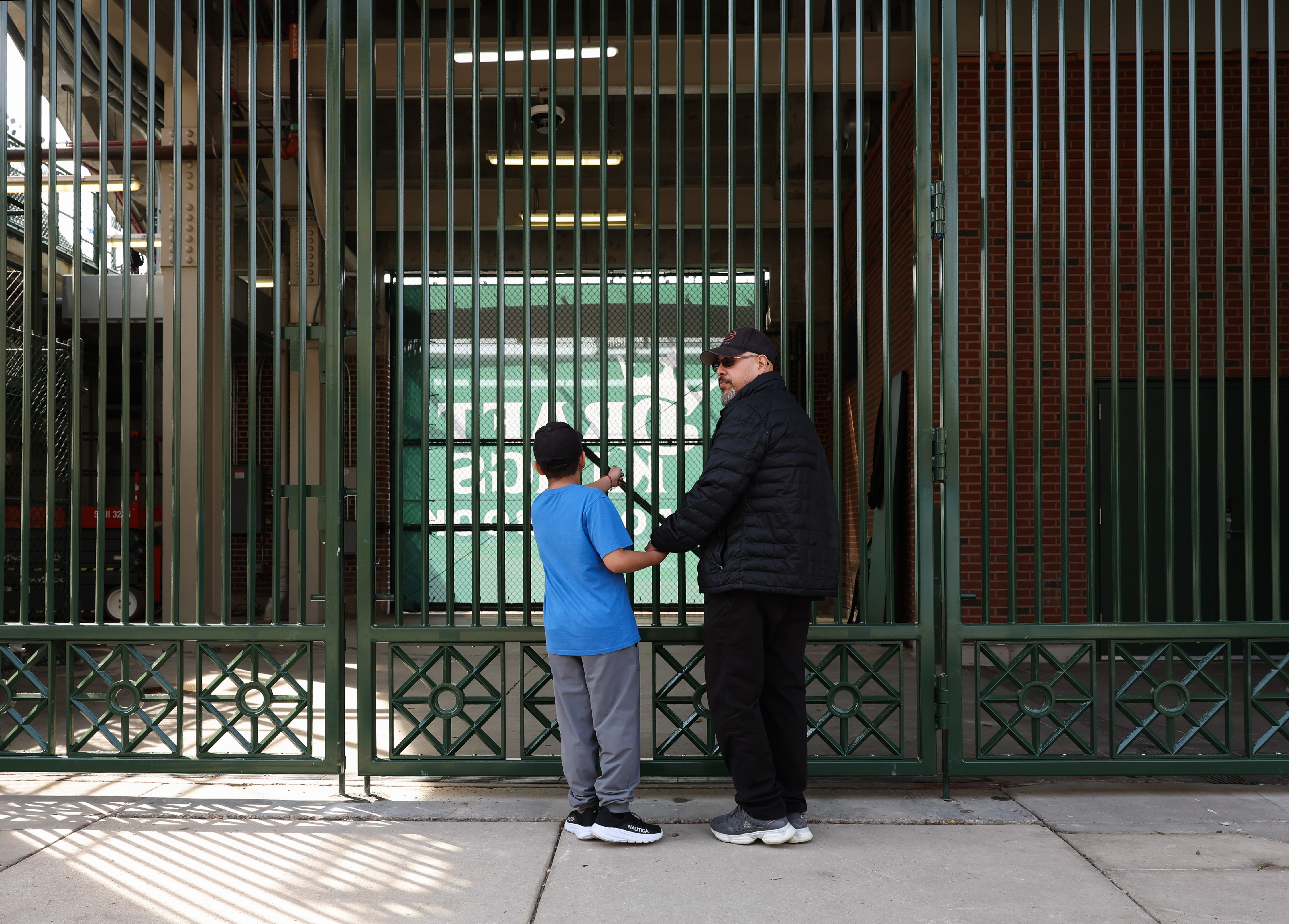 A child looks through a gate on the Sheffield Avenue...