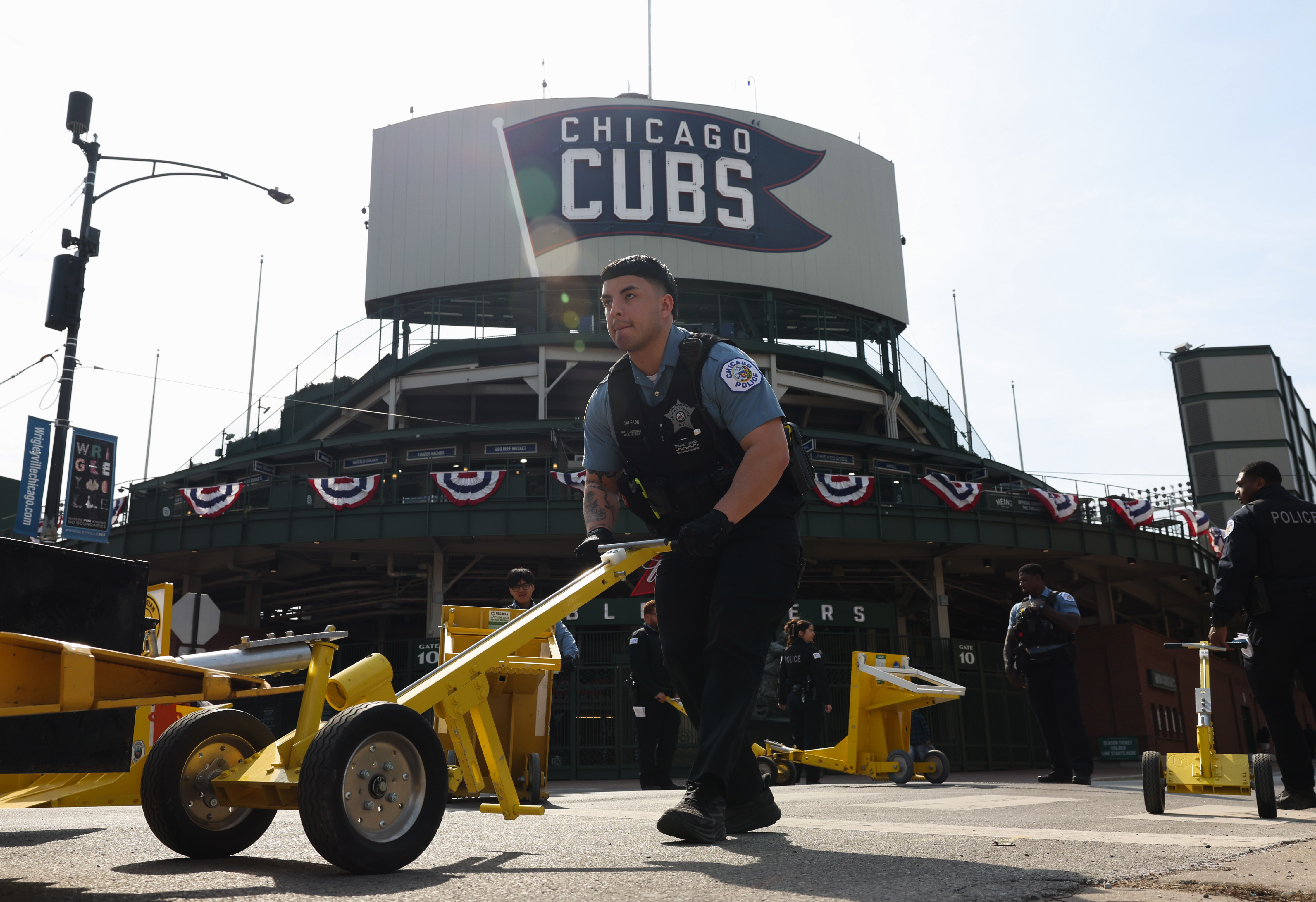Police officers move traffic security barricades on the Waveland and...