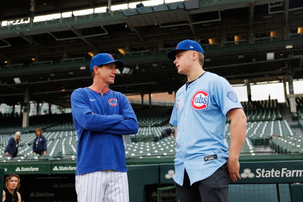 From left, Chicago Cubs manager Craig Counsell (11) talks with Ethan Conrad, who the Cubs selected at No. 17 in the first round of the 2025 MLB draft, before the Cubs play the Milwaukee Brewers at Wrigley Field Wednesday Aug. 20, 2025, in Chicago. (Armando L. Sanchez/Chicago Tribune)