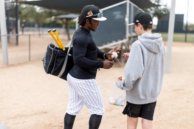 Chicago White Sox second baseman Luisangel Acuña signs a baseball for James Dykes, 14, of Elmurst, Ill., during spring training at Camelback Ranch in Glendale, Ariz., on Wednesday, Feb. 18, 2026. (Eileen T. Meslar/Chicago Tribune)