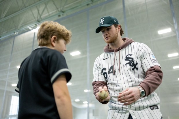 Chicago White Sox pitcher Shane Smith shows a young player the four-seam grip during the White Sox SoxFest Kids Camp on Saturday, Jan. 31, 2026, at the ComEd Recreation Center in Chicago. (Josh Boland/Chicago Tribune)
