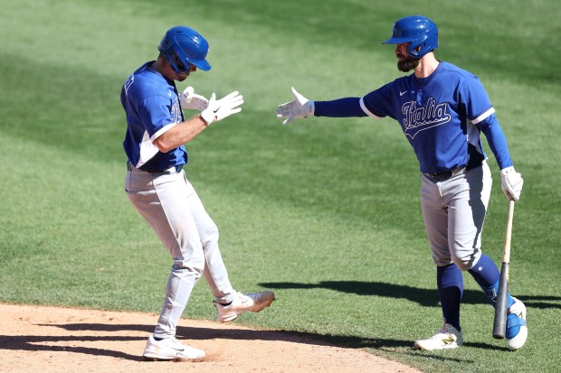Team Italy's Kyle Teel high-fives teammate Jon Berti after hitting a two-run home run against the Cubs during the sixth inning of a World Baseball Classic exhibition game at Sloan Park on March 3, 2026. in Mesa, Arizona. (Photo by Chris Coduto/Getty Images)