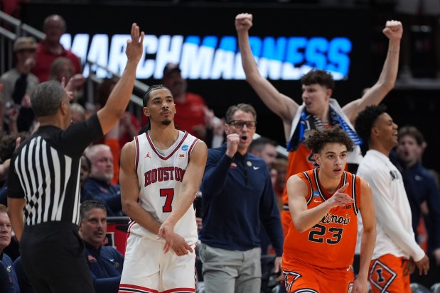Illinois guard Keaton Wagler (23) celebrates a basket alongside Houston guard Milos Uzan during the second half in the Sweet 16 of the NCAA Tournament on Thursday, March 26, 2026, in Houston. (Eric Gay/AP)