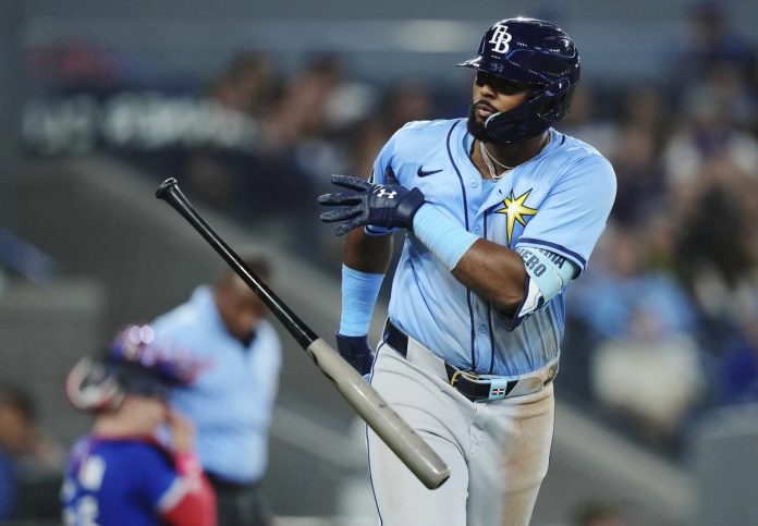 Tampa Bay Rays' Junior Caminero (13) celebrates his grand slam against the Toronto Blue Jays during ninth inning MLB baseball action in Toronto on Tuesday, May 13, 2025. (Nathan Denette/The Canadian Press via AP)