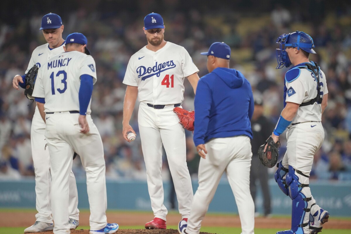 Los Angeles Dodgers manager Dave Roberts (30) relieves Los Angeles Dodgers pitcher Brock Stewart (41) in the ninth inning during an MLB game against the St. Louis Cardinals at Dodger Stadium.