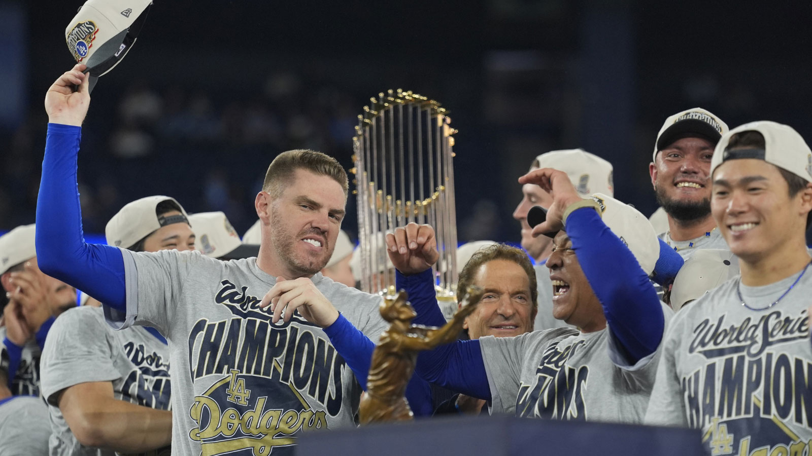 Los Angeles Dodgers first baseman Freddie Freeman (5) and manager Dave Roberts (30) celebrate on the podium after defeating the Toronto Blue Jays in the 2025 MLB World Series at Rogers Centre. 