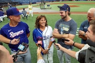 Texas Rangers' Nathaniel Lowe, left, and Tampa Bay Rays' Josh Lowe, third from left, talk to...