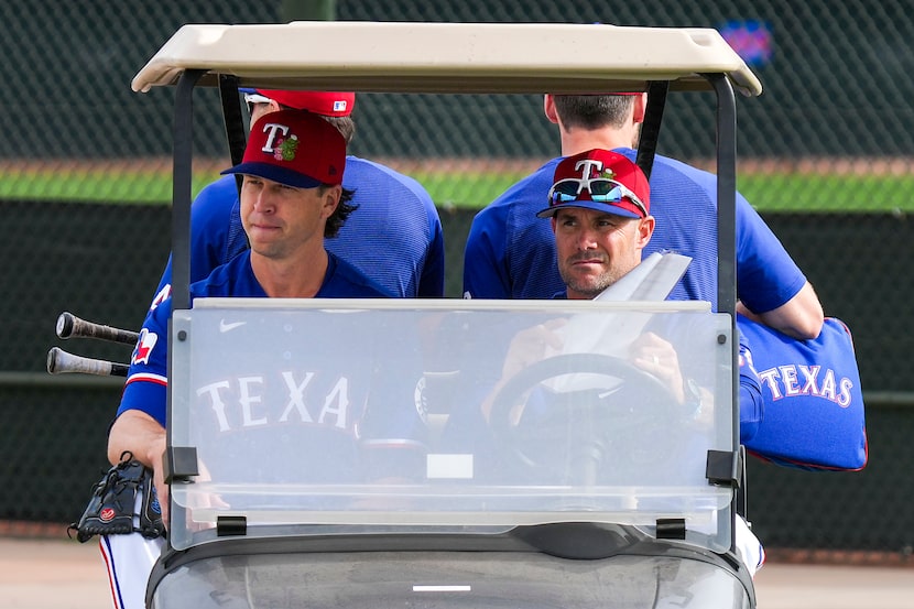 Texas Rangers pitcher Jacob Degrom (left) rides in a cart with manager Skip Schumaker during...