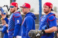 From right, Texas Rangers catcher Kyle Higashioka, catching coach Brett Hayes and catcher...