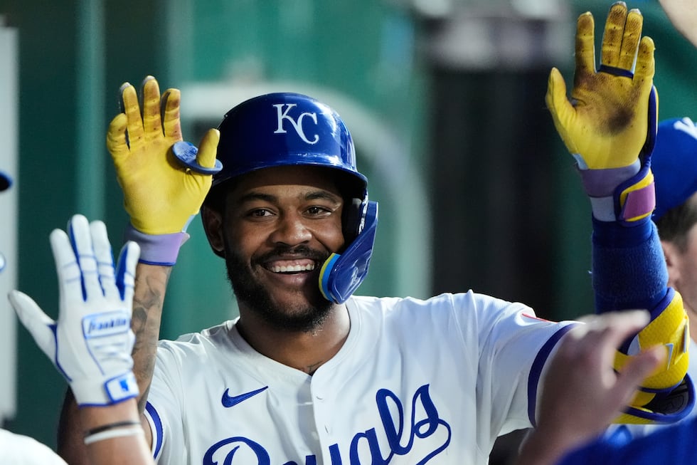 Kansas City Royals' Maikel Garcia celebrates in the dugout after hitting a solo home run...