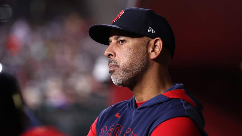 Alex Cora watches from the dugout during a Red Sox game