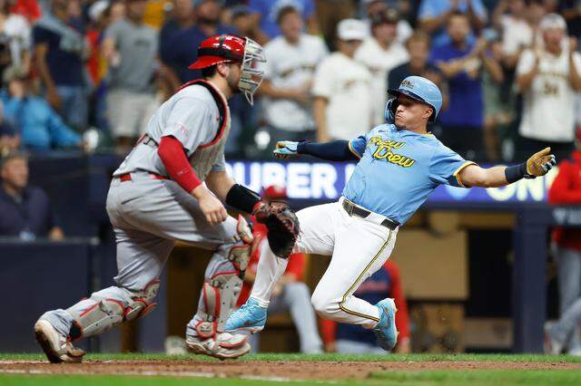 Isaac Collins #6 of the Milwaukee Brewers slides safely into home plate on a Jake Bauers #9 double in the fourth inning against the St. Louis Cardinals at American Family Field on September 12, 2025 in Milwaukee, Wisconsin.