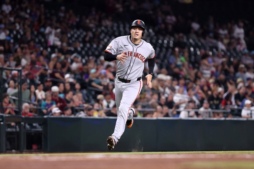 Wilmer Flores #41 of the San Francisco Giants rounds third base to score a run against the Arizona Diamondbacks during the first inning at Chase Field on September 16, 2025 in Phoenix, Arizona.