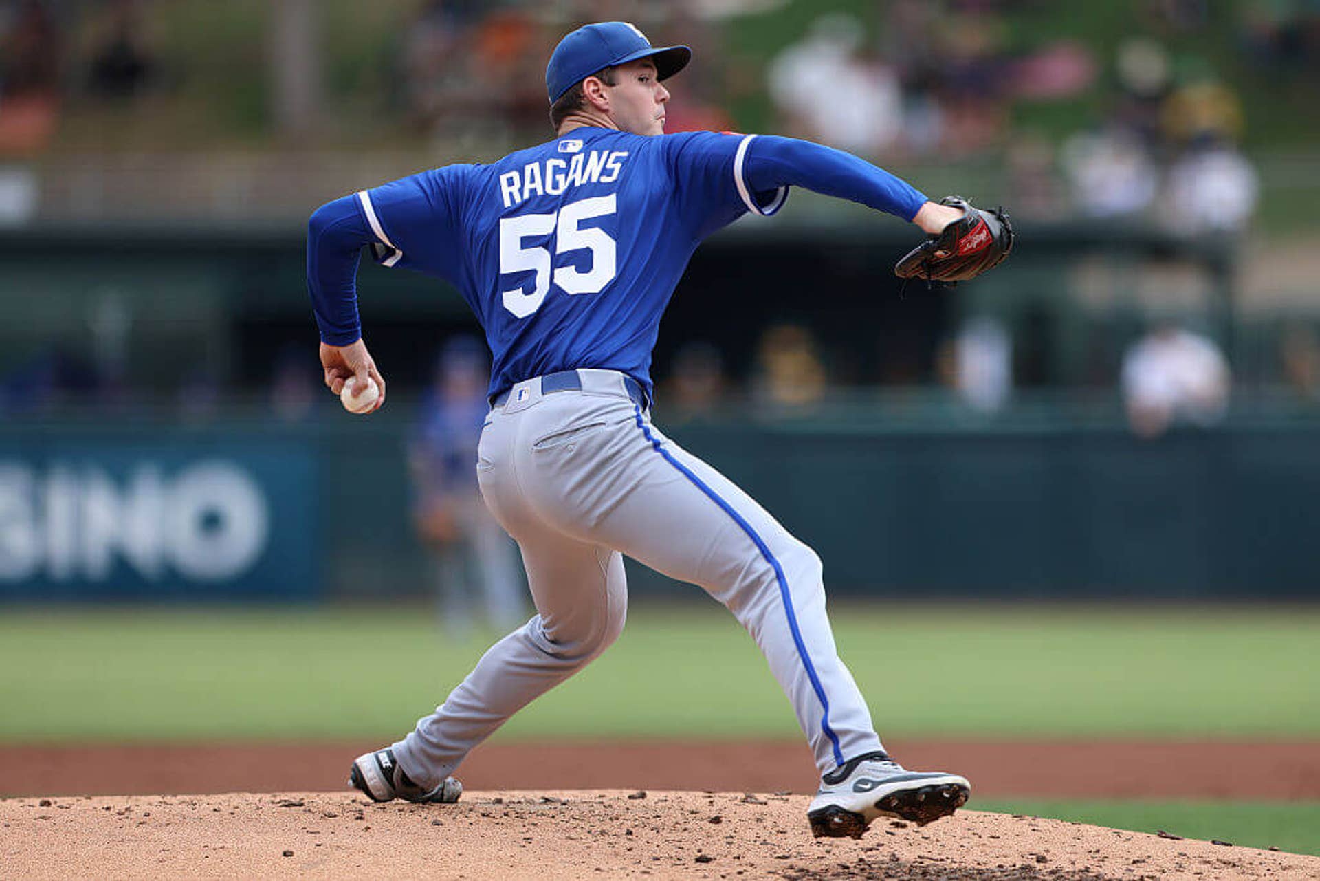 Kansas City's Cole Ragans, wearing a blue Royals jersey and hat with gray pants, strides toward home plate before releasing a pitch, ball cocked back at waist height in his left hand.