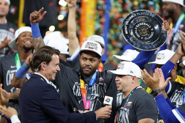 Fox Sports broadcaster Tom Verducci interviews Most Valuable Player Maikel Garcia #11 of Team Venezuela and his translator following the 3-2 victory against Team United States at loanDepot park on March 17, 2026 in Miami, Florida.