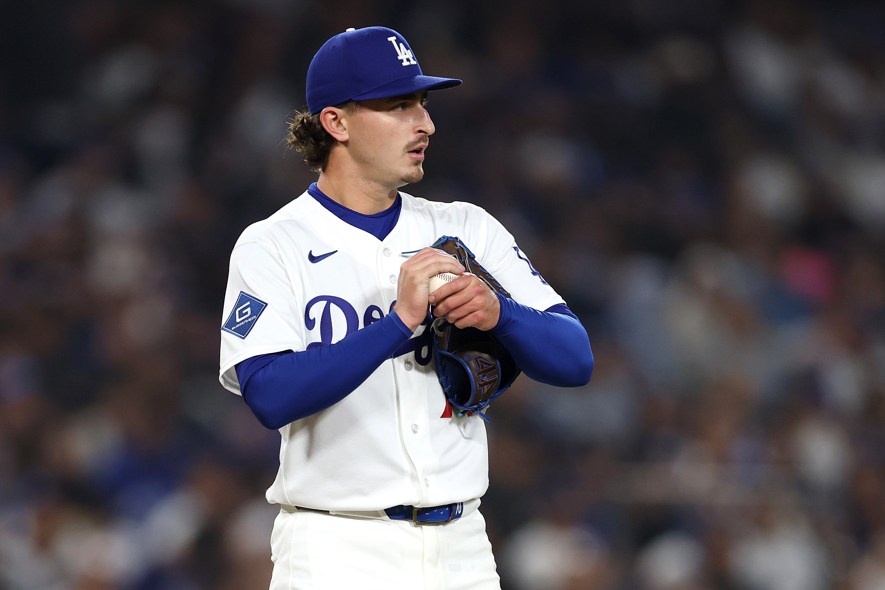 Dodgers relief pitcher Justin Wrobleski reacts as he rubs up...