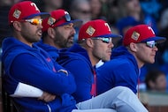 Texas Rangers manager Skip Schumaker (second from right) watches with (from left) bench...