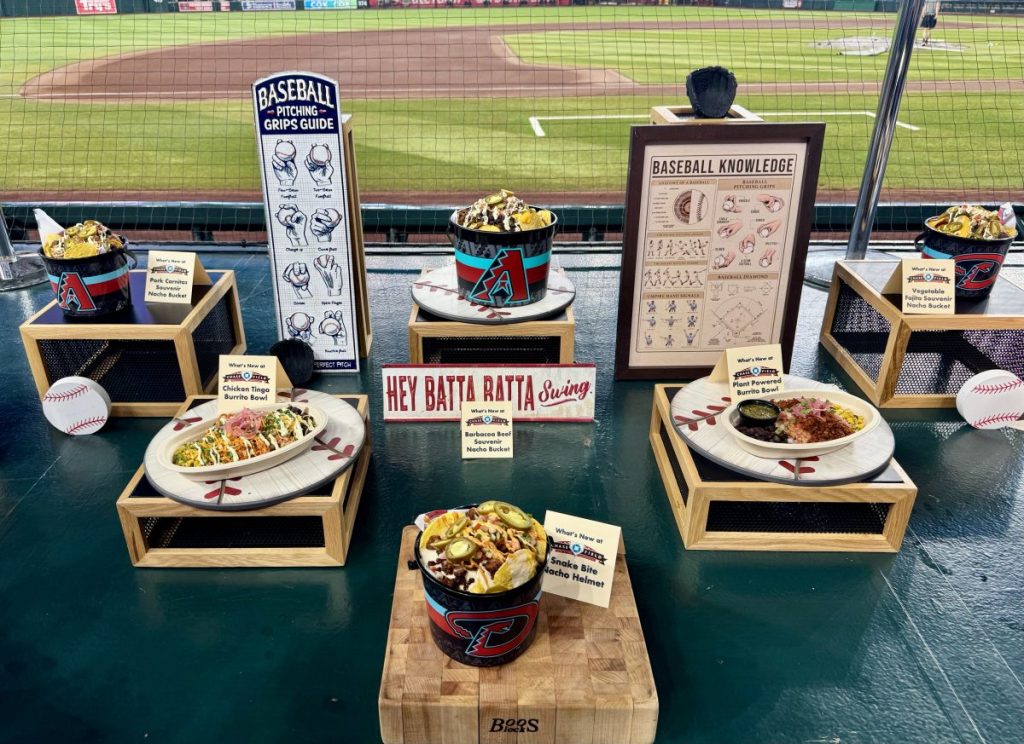 A table covered with nacho buckets, burrito bowls and more new dishes from Chase Field.