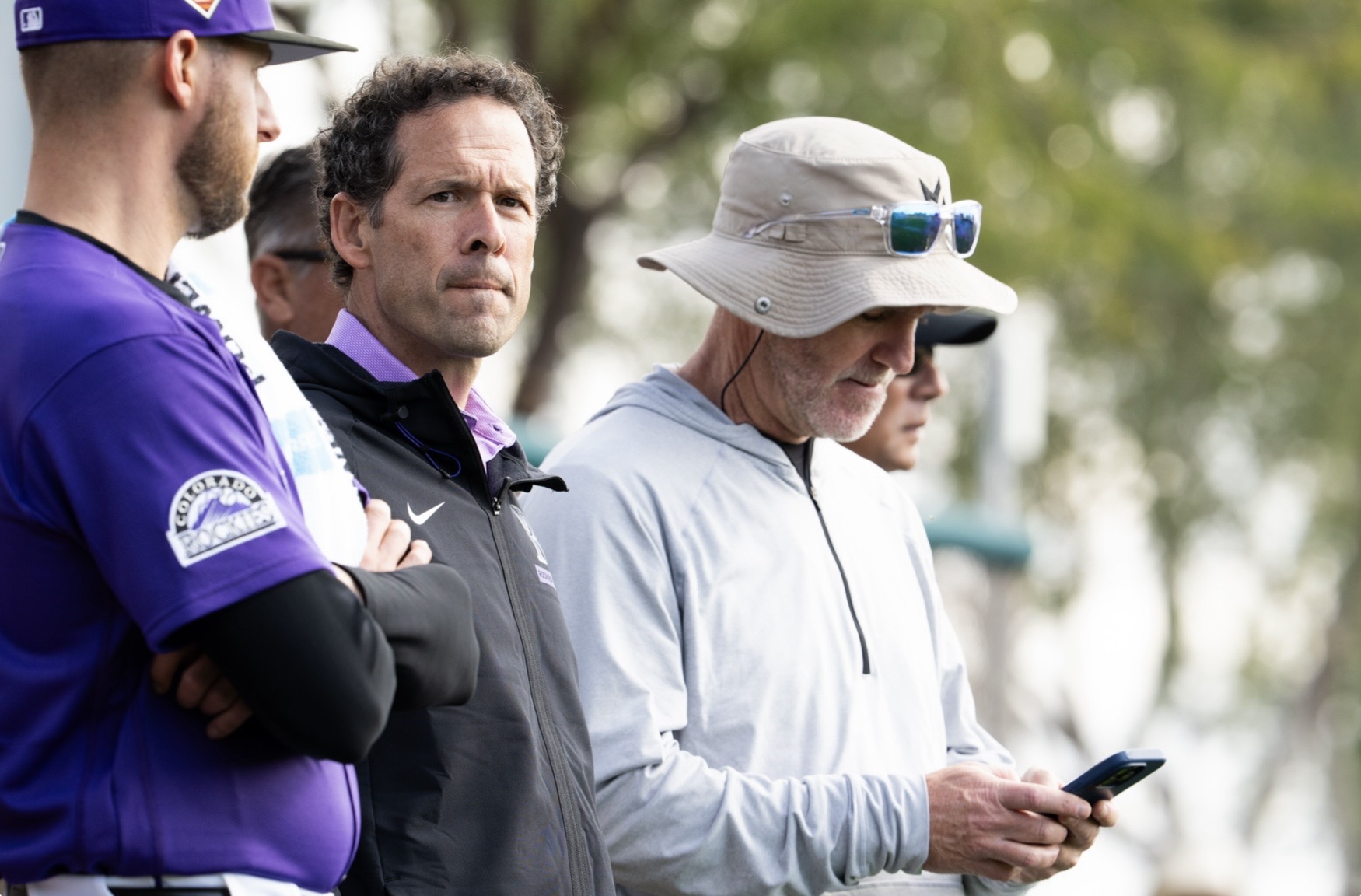 Paul DePodesta and Josh Byrnes look on at Rockies spring training.