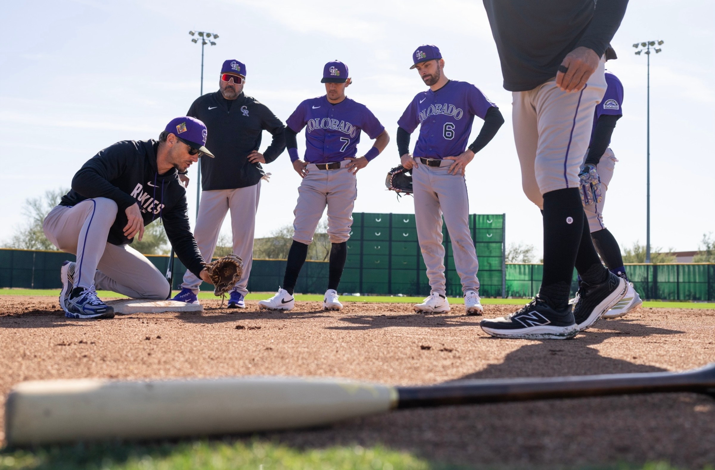 Colorado Rockies bench coach Jeff Pickler works with players on fielding during spring training in Scottsdale, Arizona.